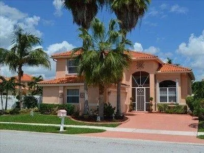 a front view of house with yard and green space