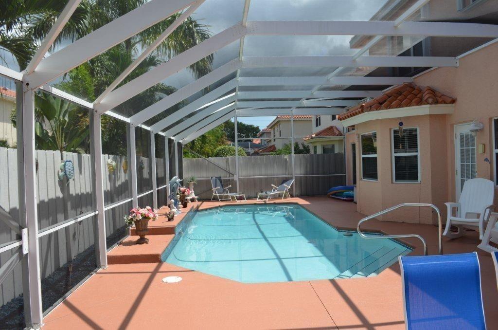 6563 Constance Street, Unit 6563 Lake Worth, FL 33467 - Photo 14 of 16 a view of a swimming pool with a patio