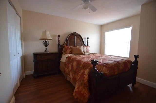 a bed sitting in a bedroom next to a window