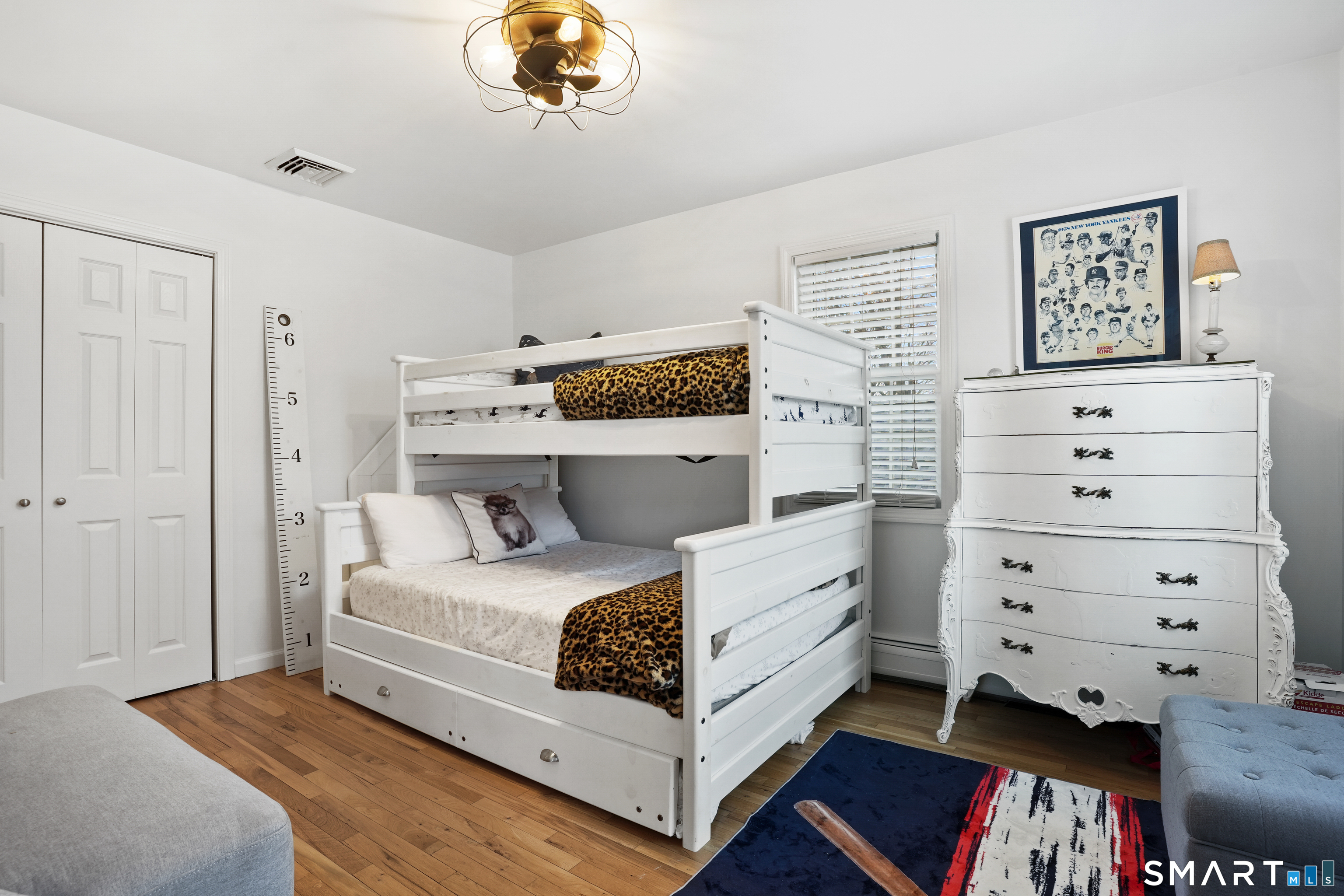 26 Abbott Avenue Ridgefield, CT 06877 - Photo 24 of 34 a bedroom with a bed and a chandelier