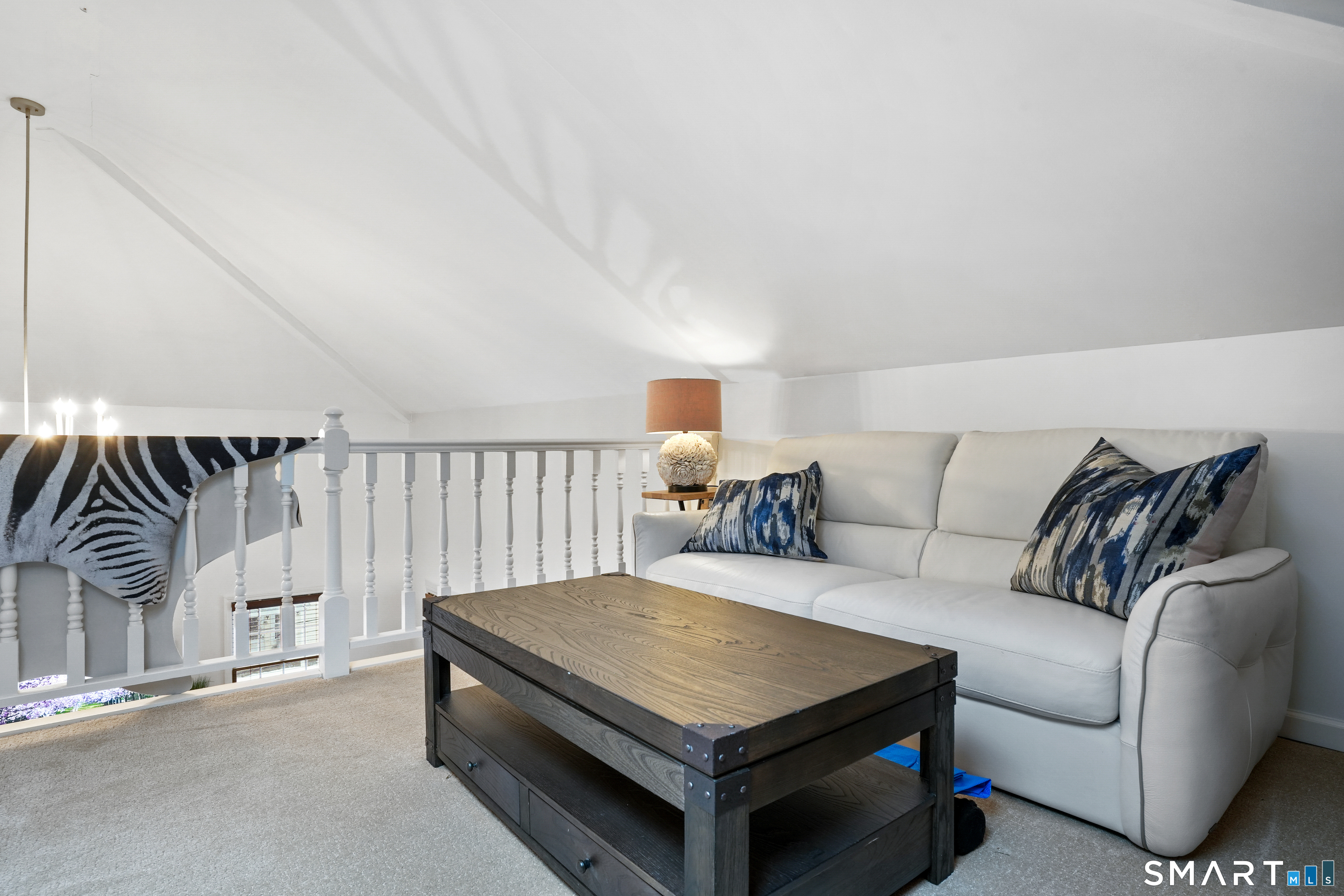 26 Abbott Avenue Ridgefield, CT 06877 - Photo 29 of 34 a living room with furniture a rug and a projector