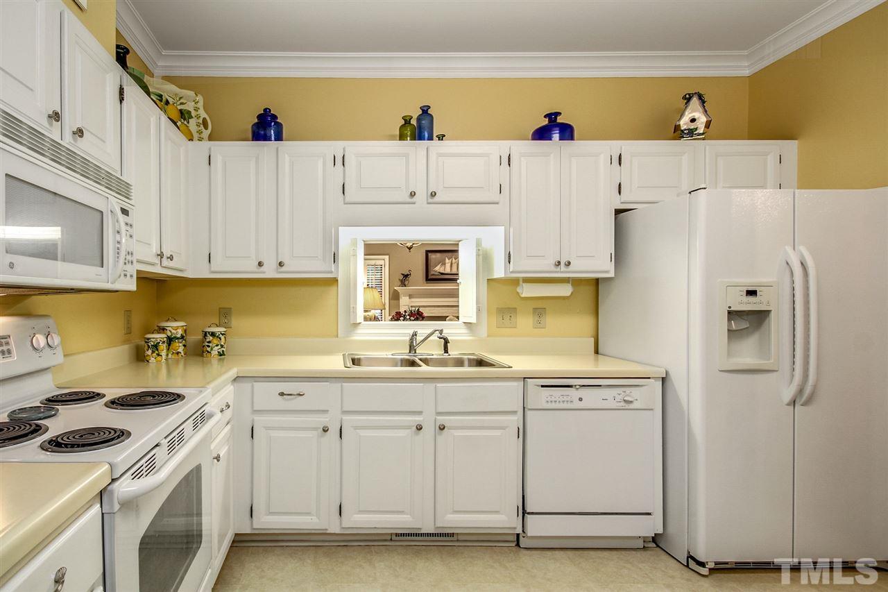 566 Weathergreen Drive Raleigh, NC 27615 - Photo 11 of 28 a kitchen with a sink a stove and refrigerator