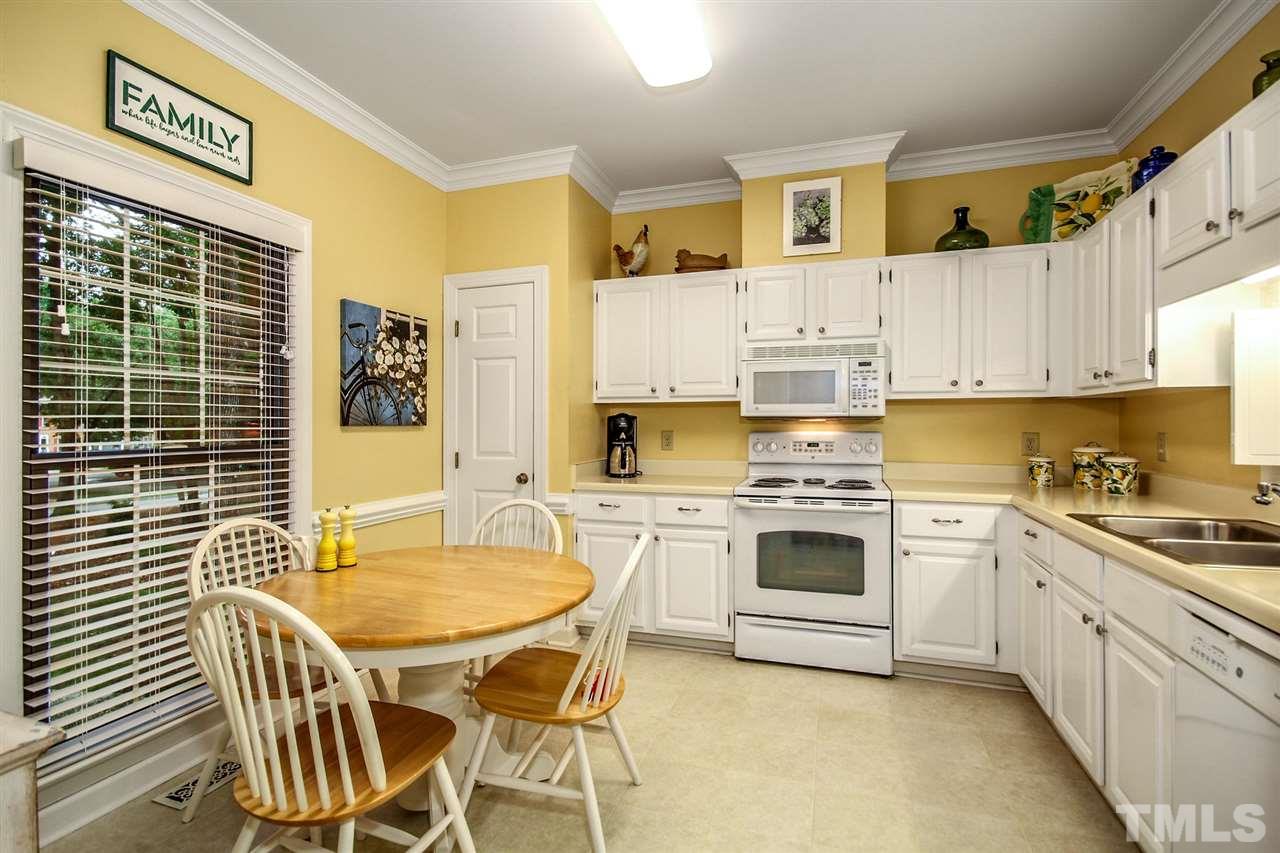 566 Weathergreen Drive Raleigh, NC 27615 - Photo 13 of 28 a kitchen with stainless steel appliances granite countertop a stove a sink dishwasher and cabinets