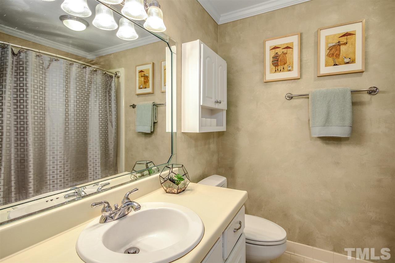566 Weathergreen Drive Raleigh, NC 27615 - Photo 17 of 28 a bathroom with a sink toilet and shower