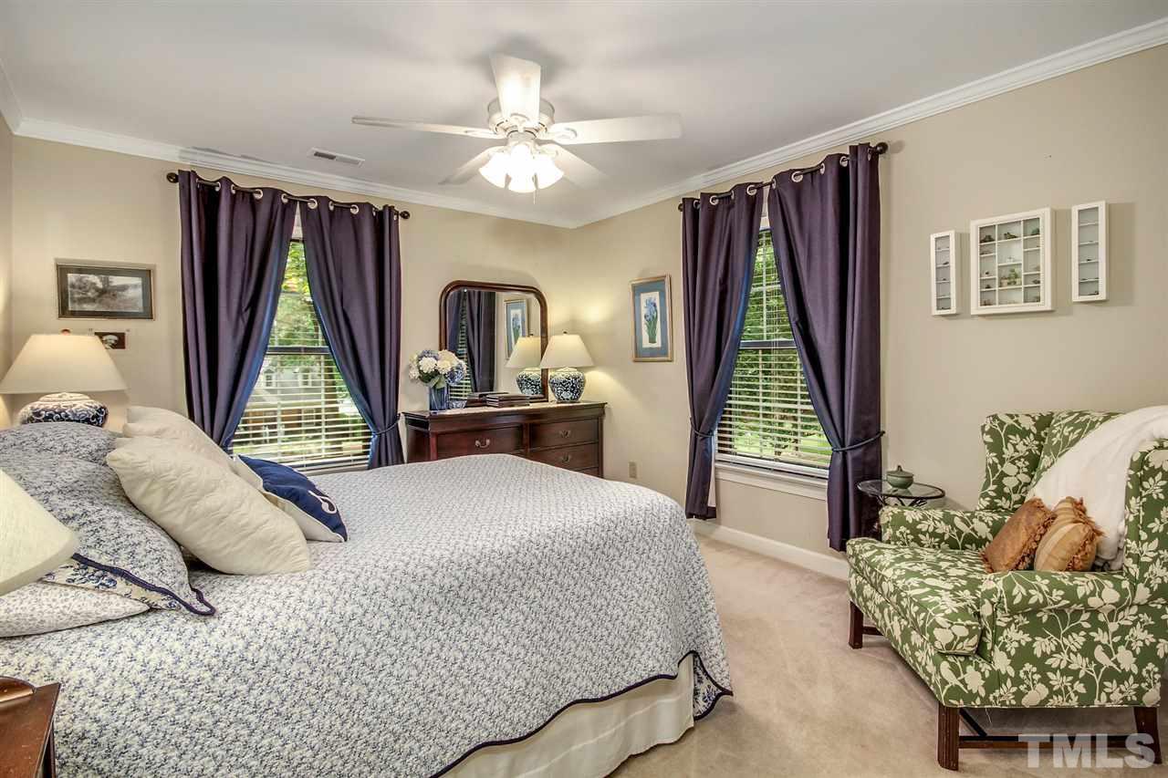 566 Weathergreen Drive Raleigh, NC 27615 - Photo 18 of 28 a bedroom with a bed and a window