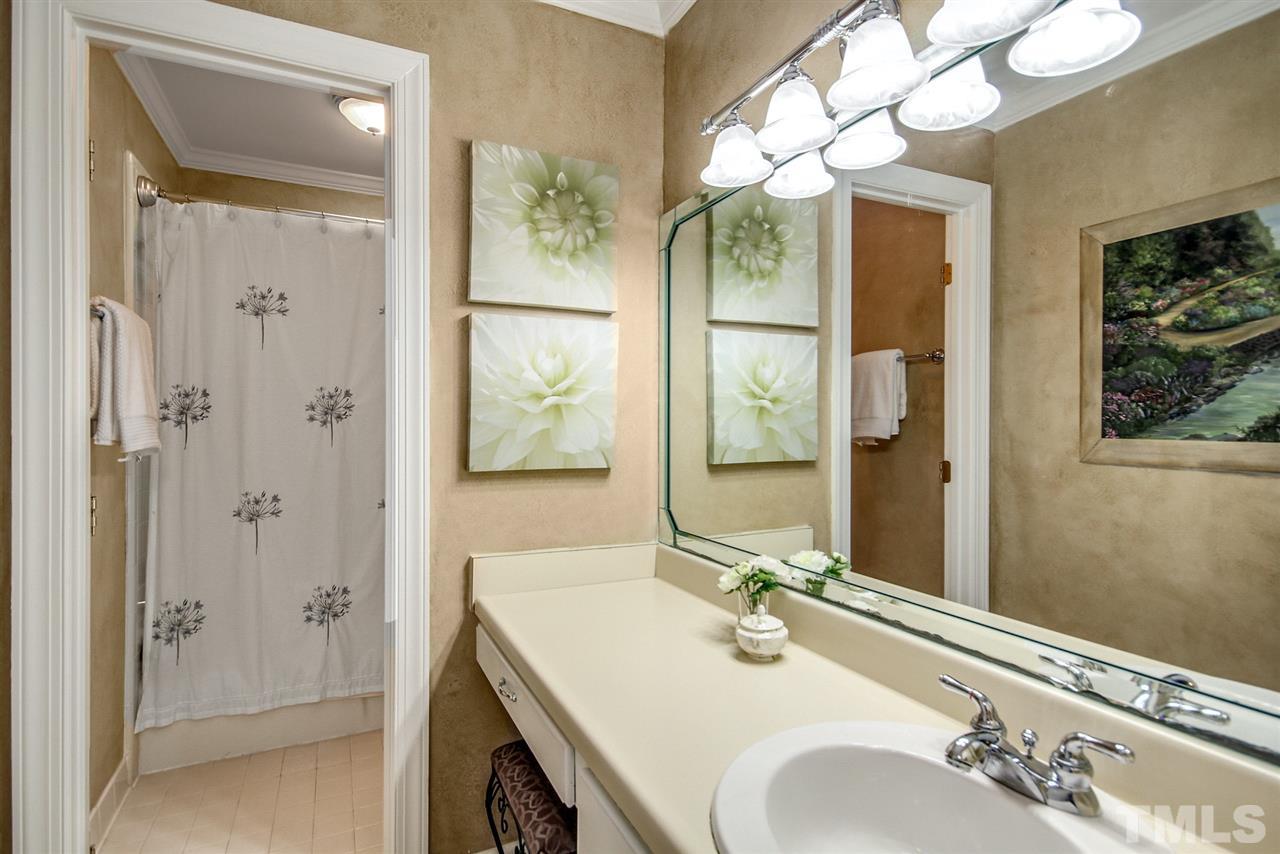 566 Weathergreen Drive Raleigh, NC 27615 - Photo 22 of 28 a bathroom with a double vanity sink mirror and shower
