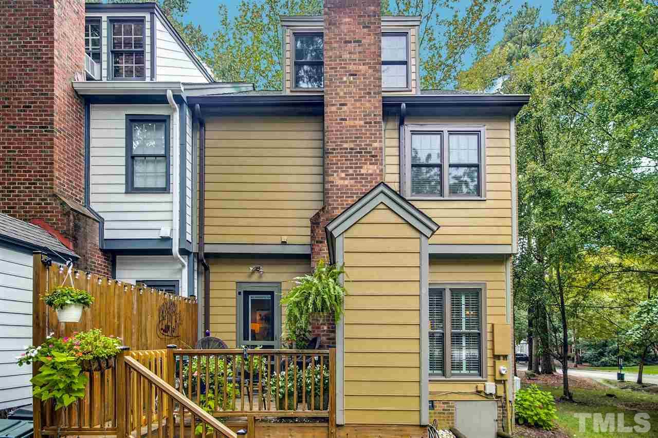 566 Weathergreen Drive Raleigh, NC 27615 - Photo 28 of 28 a view of a house with large windows and plants
