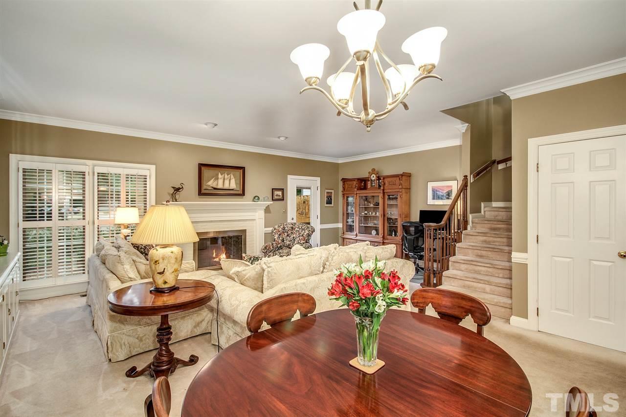 566 Weathergreen Drive Raleigh, NC 27615 - Photo 7 of 28 a living room with fireplace furniture and a chandelier