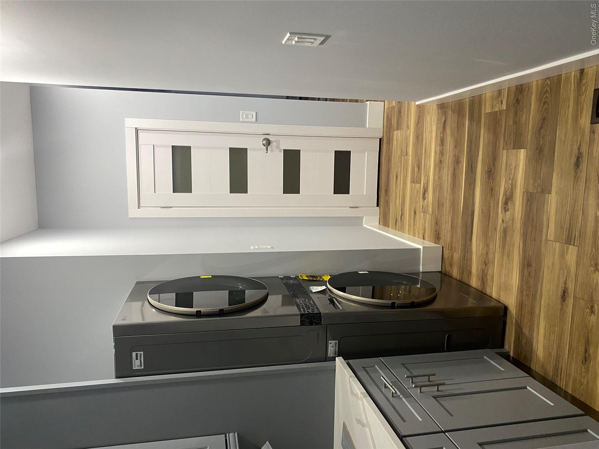 44 Roslyn Ridge Road Mongaup Valley, NY 12762 - Photo 12 of 24 Laundry area featuring light wood finished floors and stacked washer / drying machine
