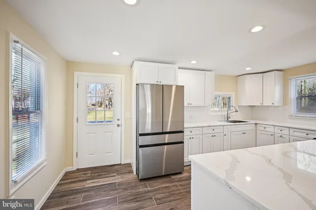 a kitchen with a refrigerator stove and sink