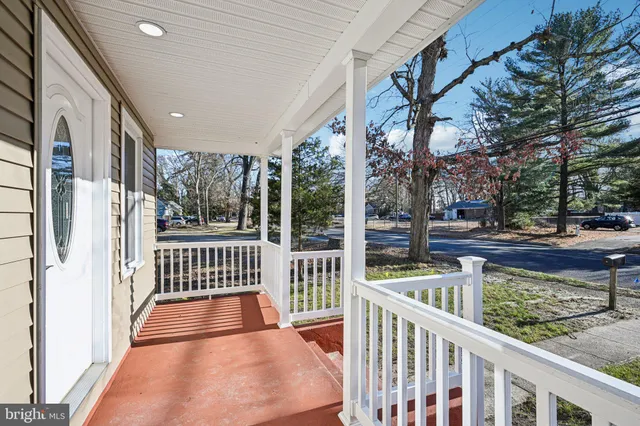 a view of a porch with wooden floor and fence