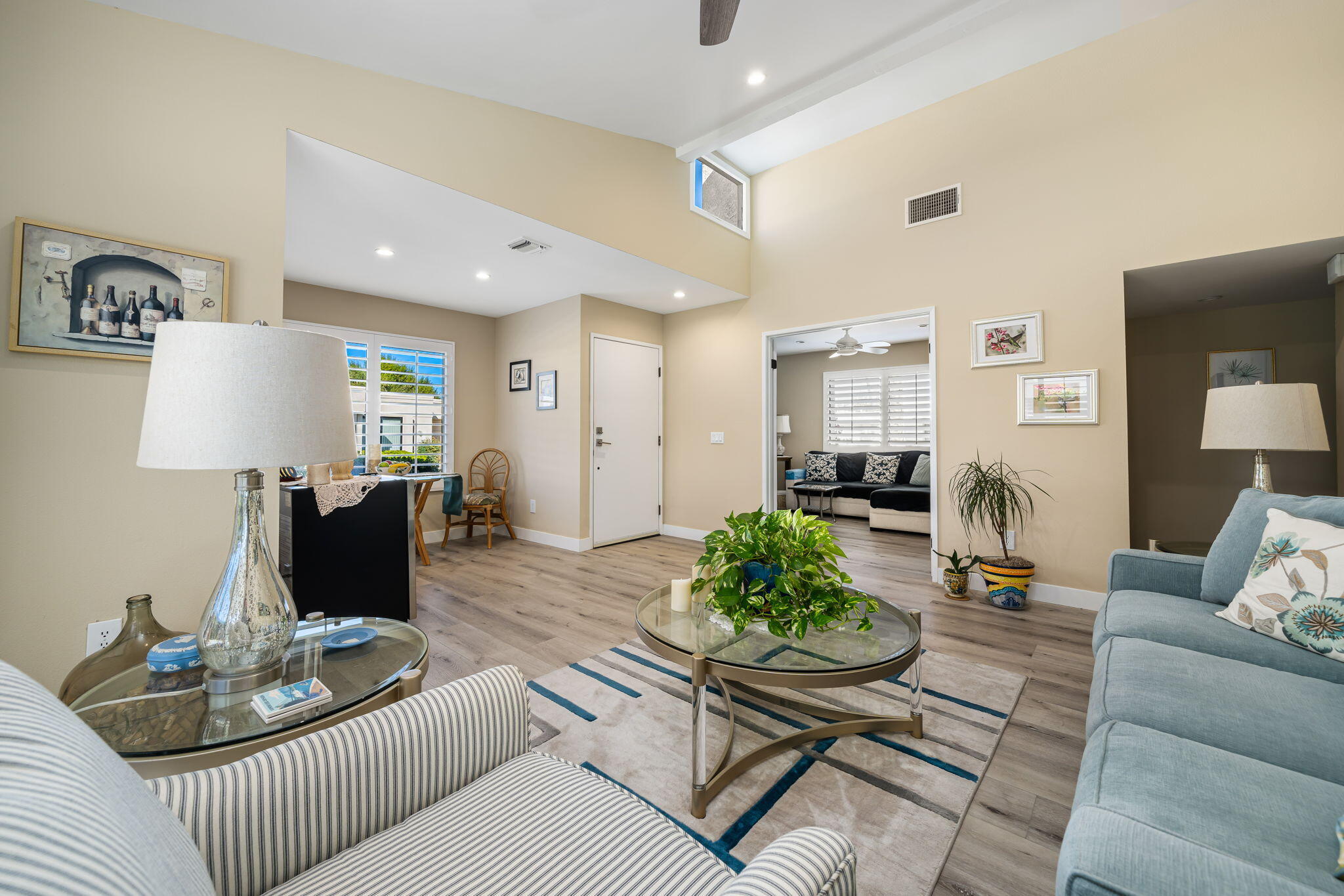 255 Vía Rengo Palm Desert, CA 92260 - Photo 12 of 32 a living room with furniture and a table