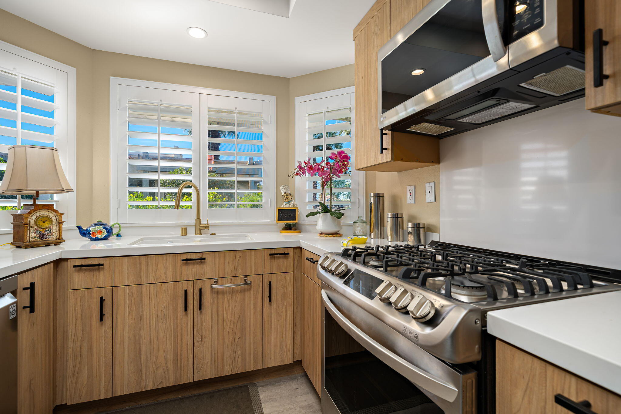 255 Vía Rengo Palm Desert, CA 92260 - Photo 15 of 32 a kitchen with a stove a sink and a window