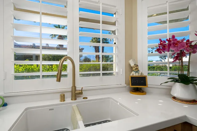 a bedroom with a bed a ceiling fan and a fireplace