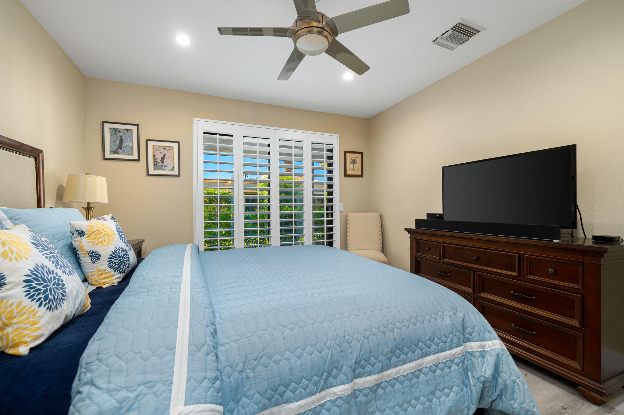 255 Vía Rengo Palm Desert, CA 92260 - Photo 19 of 32 a bedroom with a bed and a flat screen tv