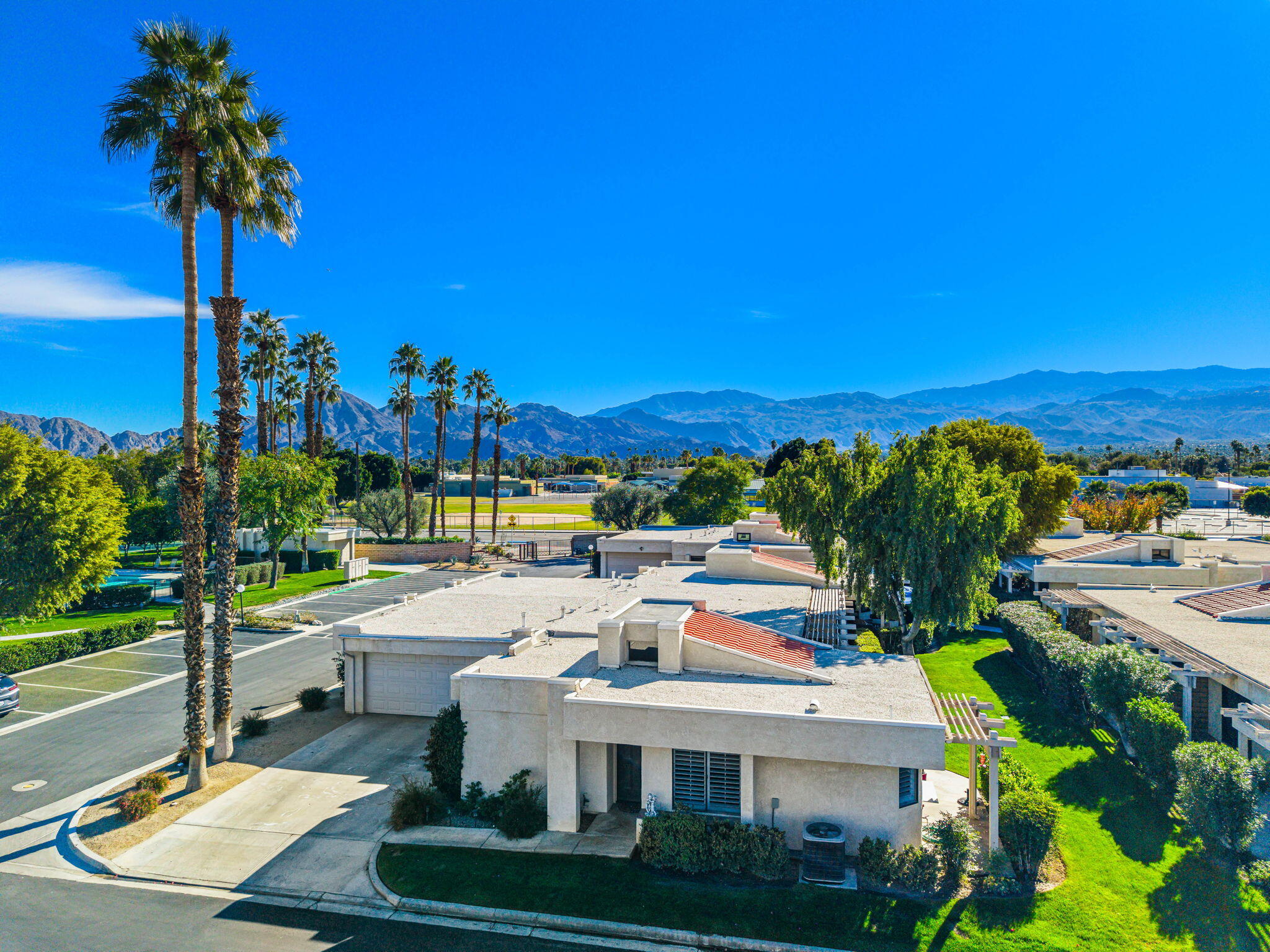 255 Vía Rengo Palm Desert, CA 92260 - Photo 2 of 32 a view of a swimming pool and lounge chairs
