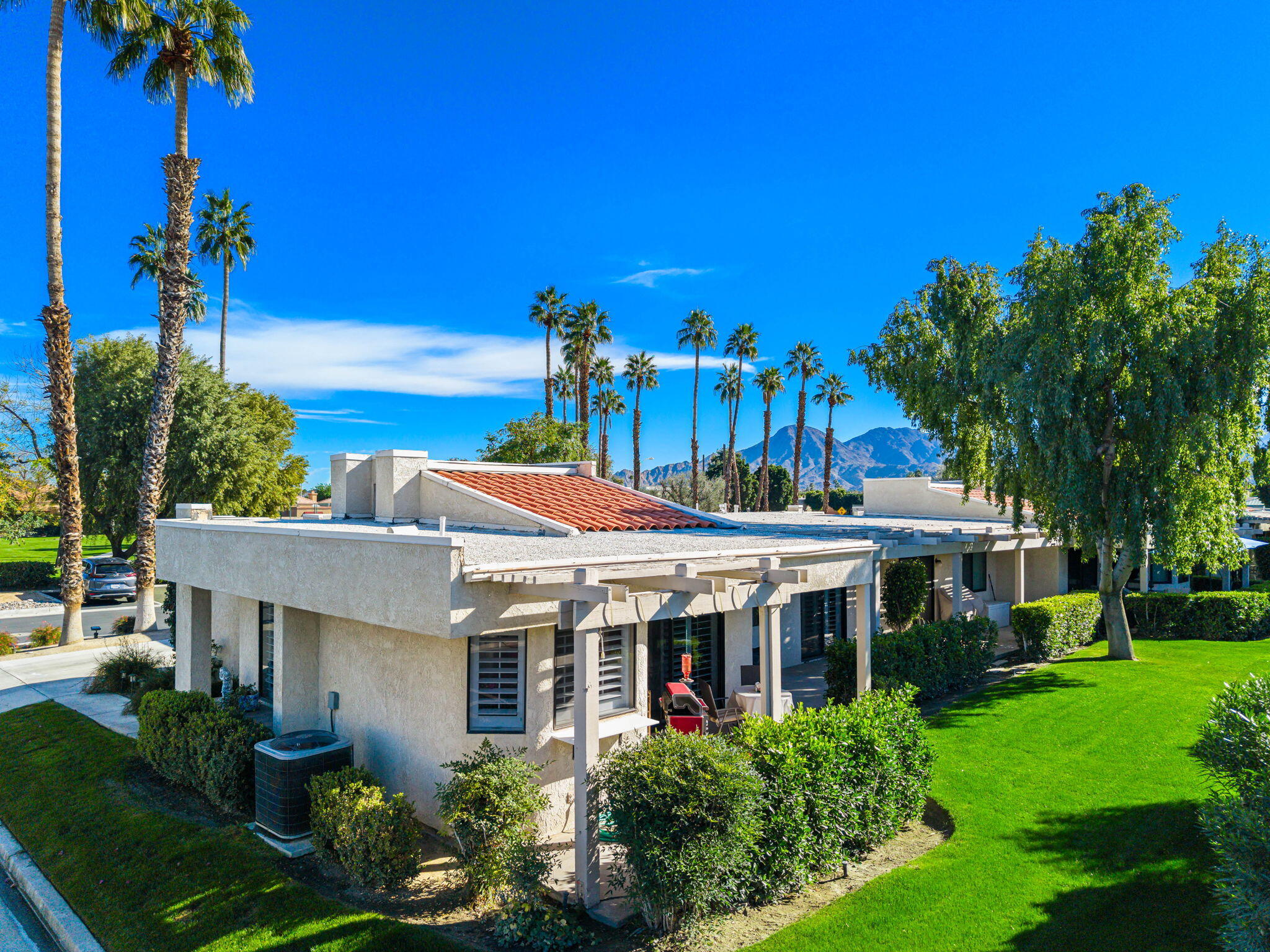 255 Vía Rengo Palm Desert, CA 92260 - Photo 24 of 32 a front view of a house with a yard