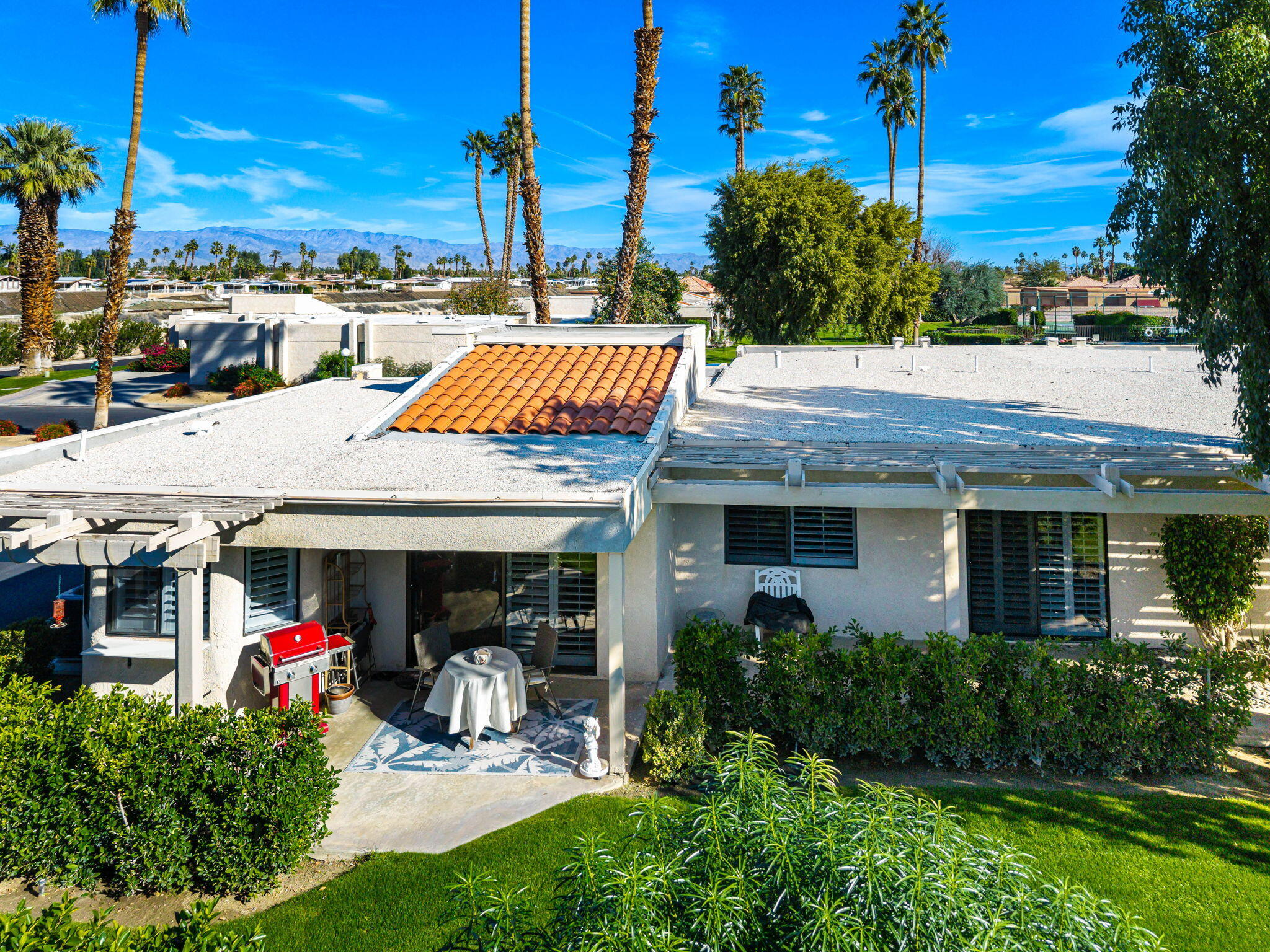 255 Vía Rengo Palm Desert, CA 92260 - Photo 26 of 32 a view of a house with sitting area and garden