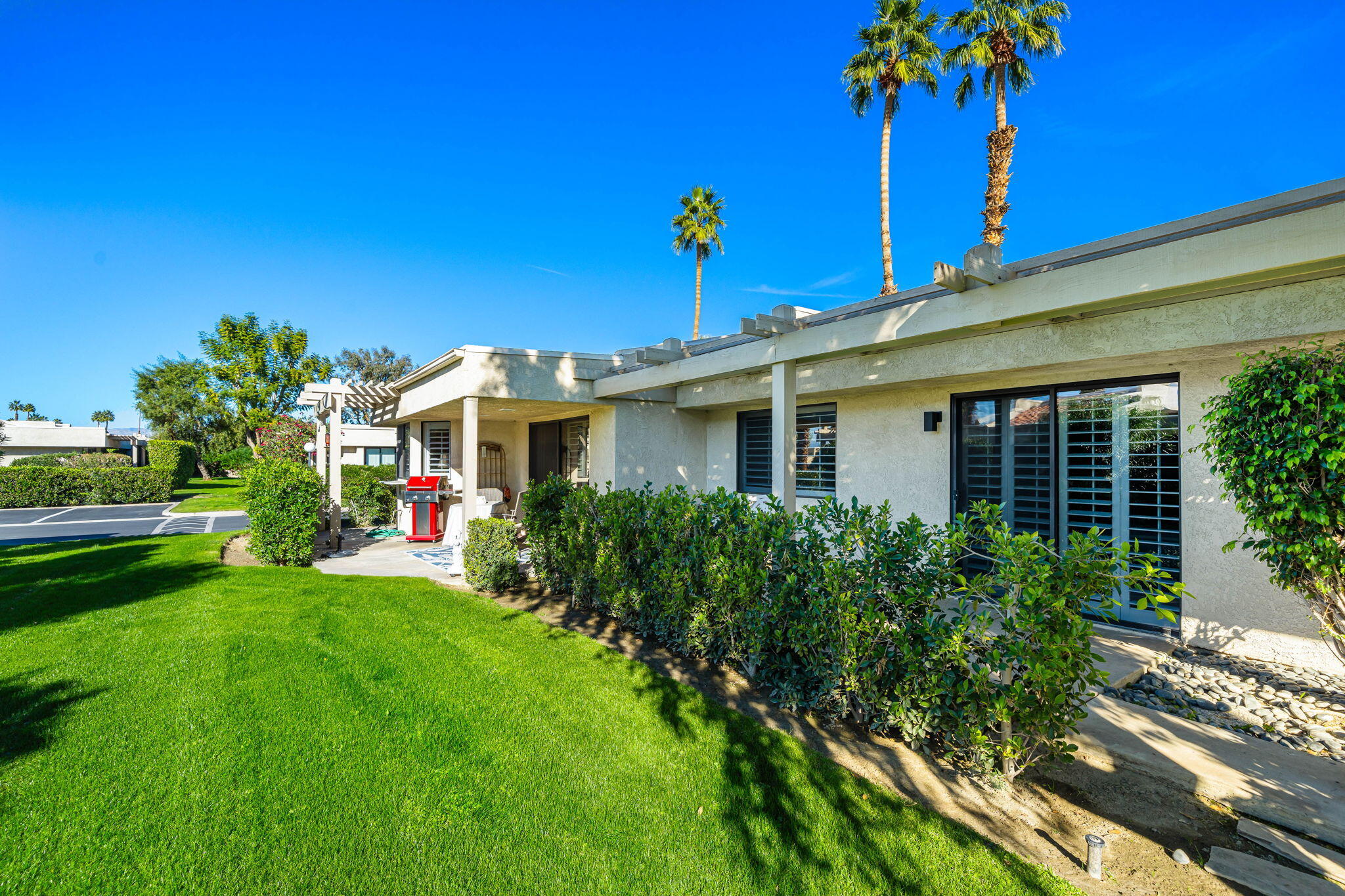 255 Vía Rengo Palm Desert, CA 92260 - Photo 28 of 32 a view of a house with a yard