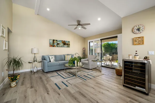 a living room with furniture and a floor to ceiling window