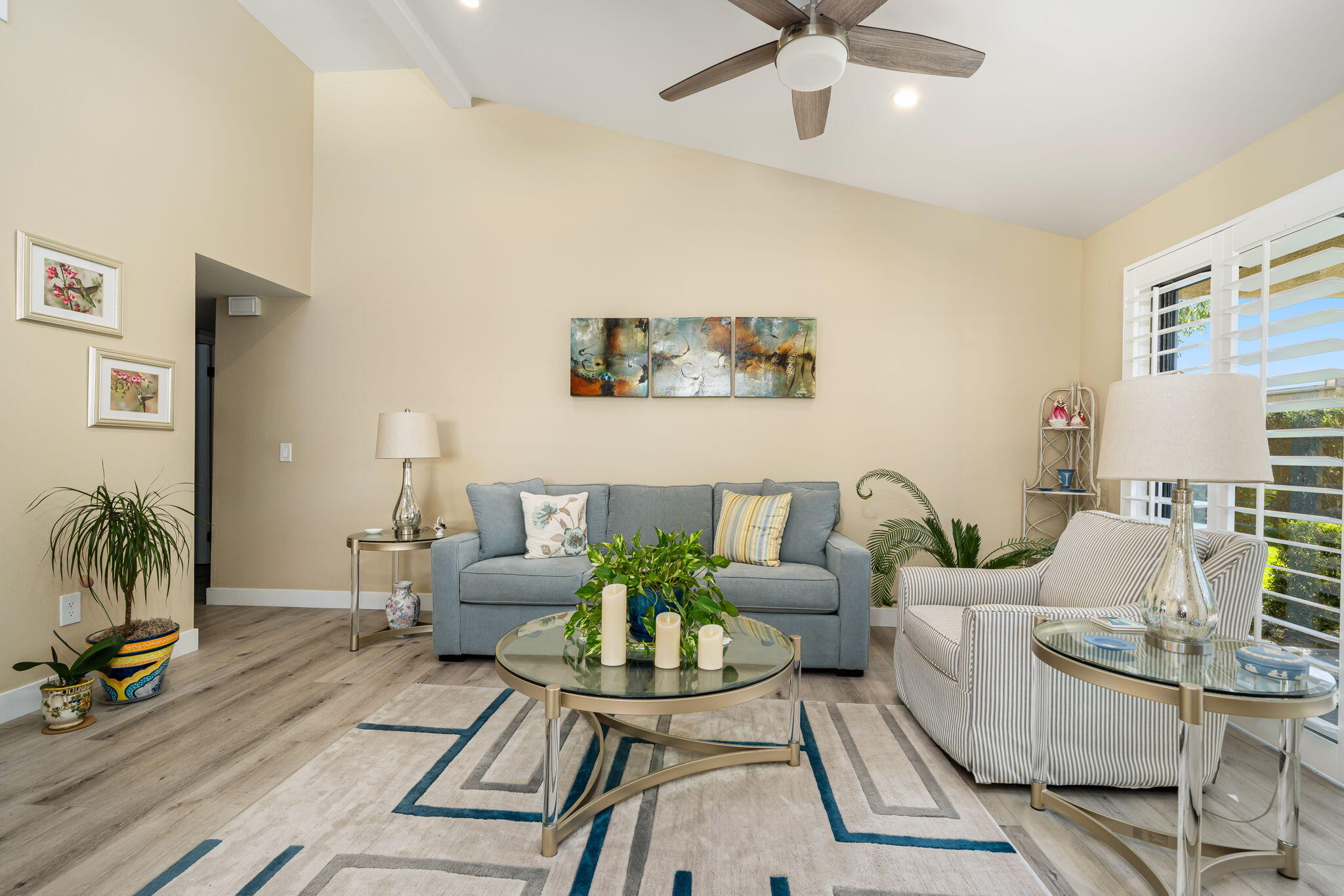 255 Vía Rengo Palm Desert, CA 92260 - Photo 10 of 32 a living room with furniture and a floor to ceiling window