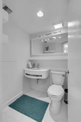 a bathroom with a toilet a sink and view