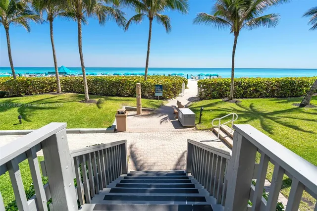 a view of a tall building with a bench in front of it
