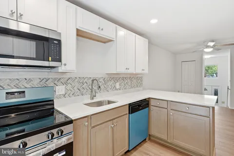 a kitchen with a sink stove and cabinets