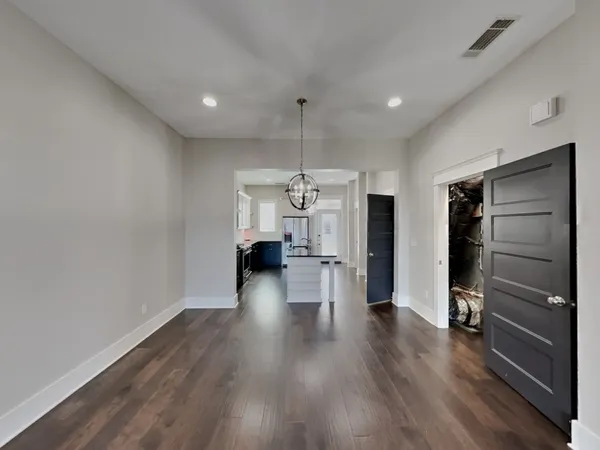 a view of a room with wooden floor window and a ceiling fan