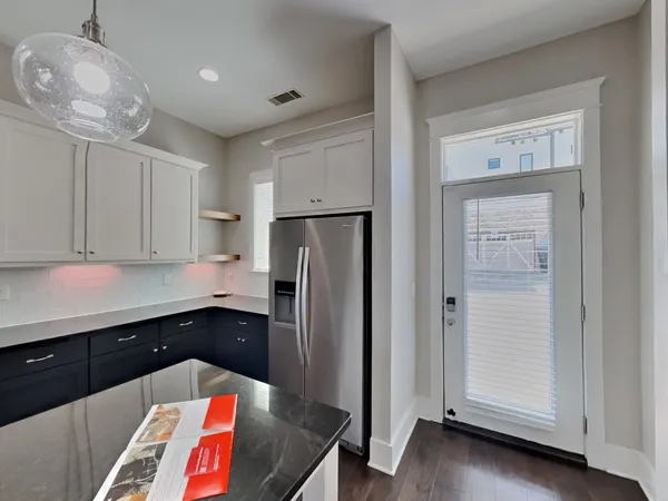 a kitchen with stainless steel appliances a refrigerator and cabinets