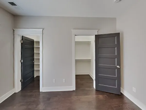 a view of walk in closet with empty racks