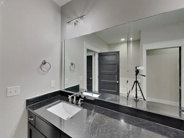 a bathroom with a sink and a mirror