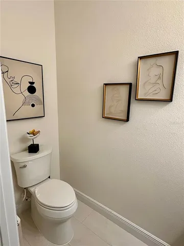 a white toilet sitting next to a bathroom sink