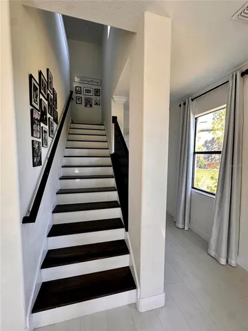 a view of entryway with wooden floor and stairs