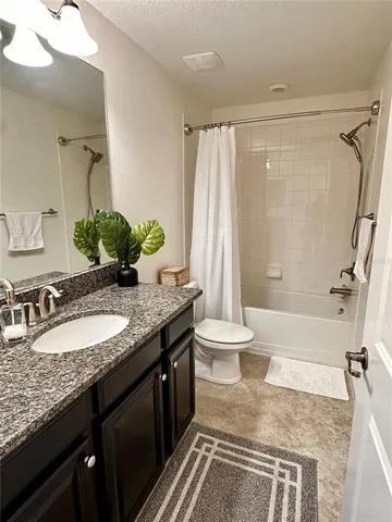 a bedroom with a bed couch and window