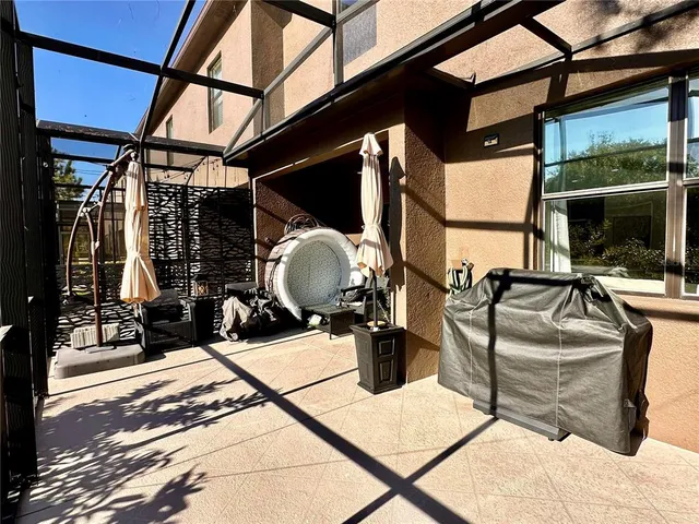 a view of a balcony with chairs and wooden floor