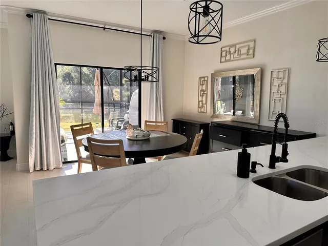 a living room with large window and furniture