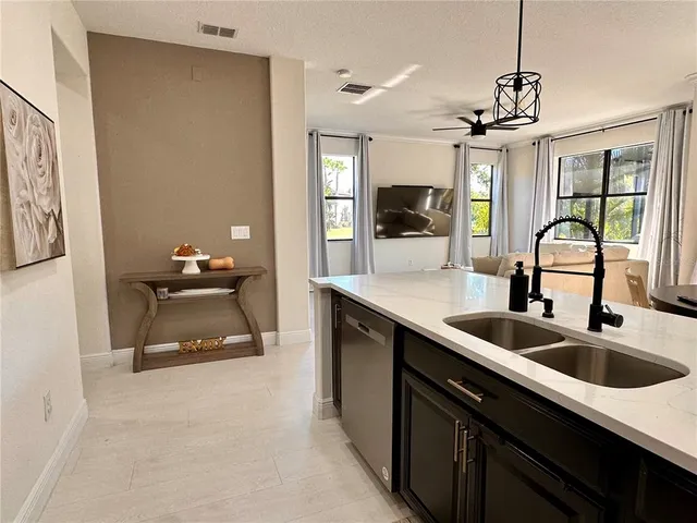 a kitchen with a sink appliances and a window