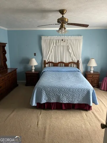 a bedroom with a bed and a lamp