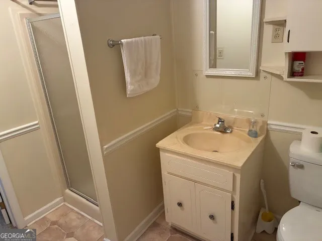 a bathroom with a sink toilet and mirror