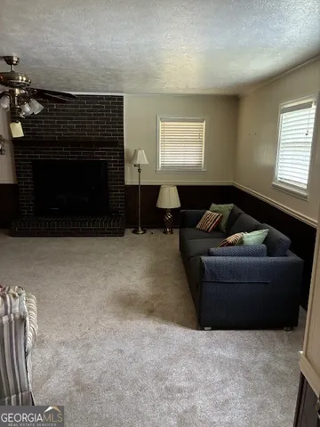 a living room with furniture and a fireplace
