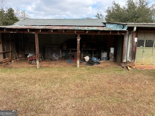 a backyard of a house with shaded area