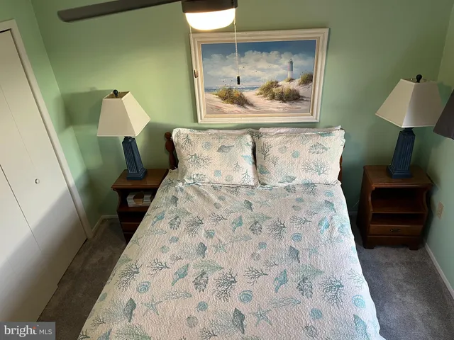 a bed room with a bed and a painting on the wall