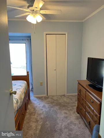 a bedroom with bed and a chandelier