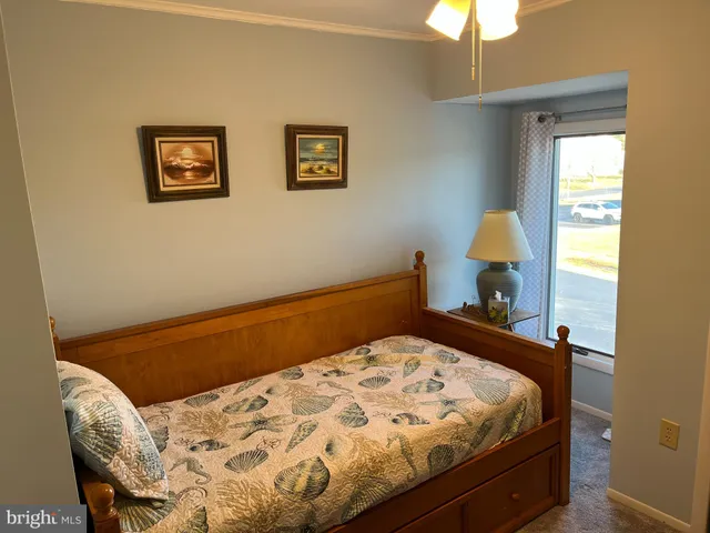 a bedroom with a bed and a lamp