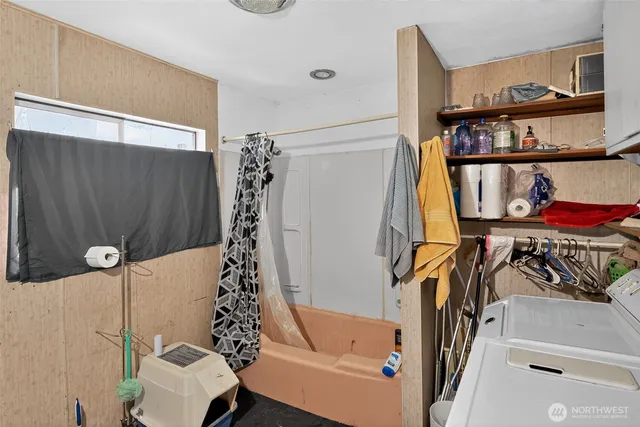 a bathroom with a bathtub and a shower