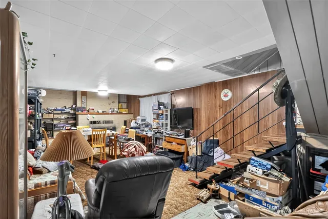 a living room with lots of furniture and a flat screen tv