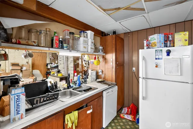 a kitchen with stainless steel appliances granite countertop a refrigerator and a stove