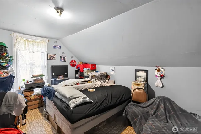 a bedroom with furniture and a flat screen tv
