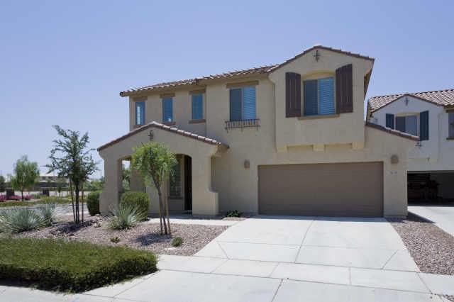 3815 East Chickadee Road Gilbert, AZ 85297 - Photo 1 of 9 a front view of a house with garden